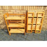 A pair of folding display shelving units,