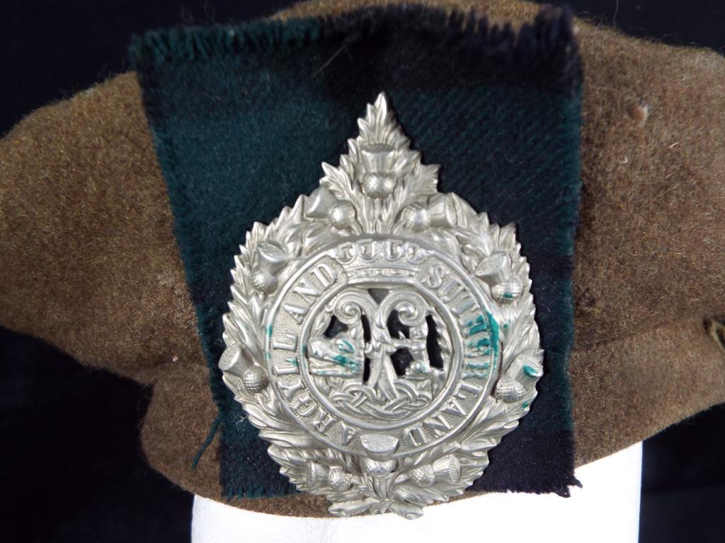 A World War Two (WWII) Argyll and Sutherland Tam O' Shanter with cap badge and tartan backing. - Image 2 of 2