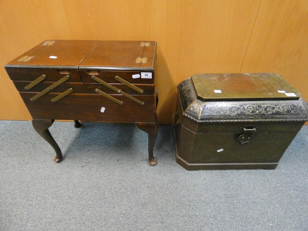 A good quality cantilever sewing box raised on four supports and a storage chest with Fleur De Lis