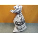 A heavy sealed sack of unsorted costume jewellery approximately 28 kg total weight.