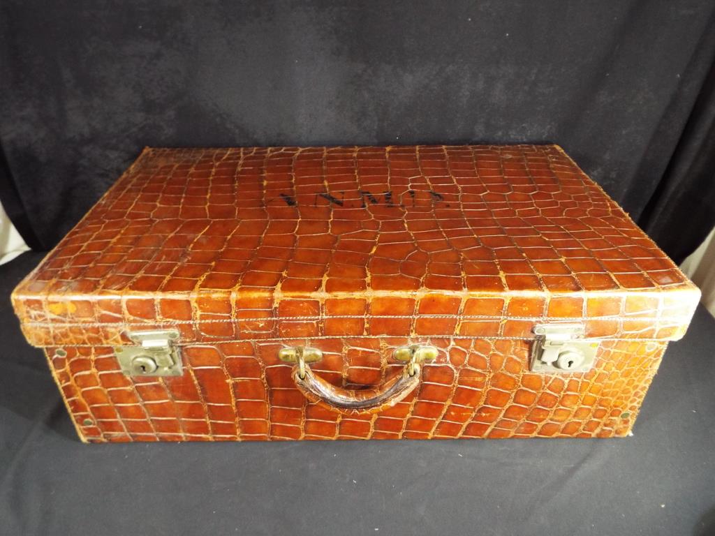 An early 20th century crocodile suitcase by the North West Tanner and Co Limited Cawnpore [Kampur]