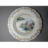 A hand painted Oriental shallow bowl with scalloped edge, decorated with landscape scene,