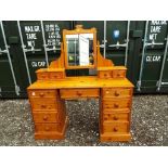 A nine drawer pine dressing table with mirror,