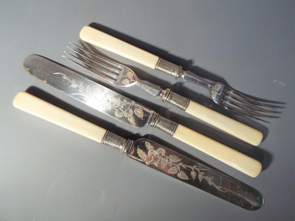An Art Deco canteen of 12 pairs of fruit knives and forks with chased foliate decoration - Image 3 of 3