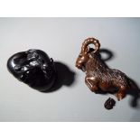 Netsuke - two vintage dark wood Japanese netsukes, one in a form of a running mountain sheep,