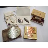 A silver stone set pendant, stamped 925 SND, two silver brooches, purchased from Charles Garnier,