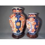 Two Oriental vases on hardwood stands, largest approximately 31 cm [h] without the stand [2].