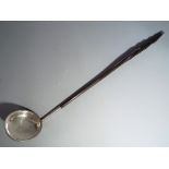 A Georgian white metal (presumed silver) toddy ladle with bone handle
