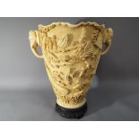 A large Oriental style vase with relief decoration, approximately 32 cm [h].