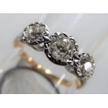 An 18 carat gold and platinum triple stone diamond ring, approximately 60 - 70 points of diamond,