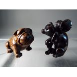 Netsuke - two vintage dark wood Japanese netsukes, one in a form of a Pug dog,