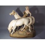 A Royal Dux figural group depicting a man with two horses riding one bareback and leading the other