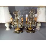 Two lustre table lamps on wooden plinths with gilded highlights and a further matched pair of