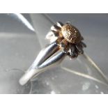 A silver hallmarked fashion ring in a form of a daisy ring size is O.