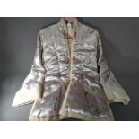 An Asian silk housecoat with slip pockets, ca 1960s, unused, approximate length 70 cm.