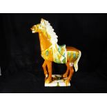 A large figurine depicting a horse with a salt glaze finish,