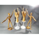 Two wooden jointed hands and two artist manikins (4)