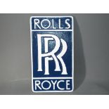 A blue and white wall plaque marked Rolls Royce