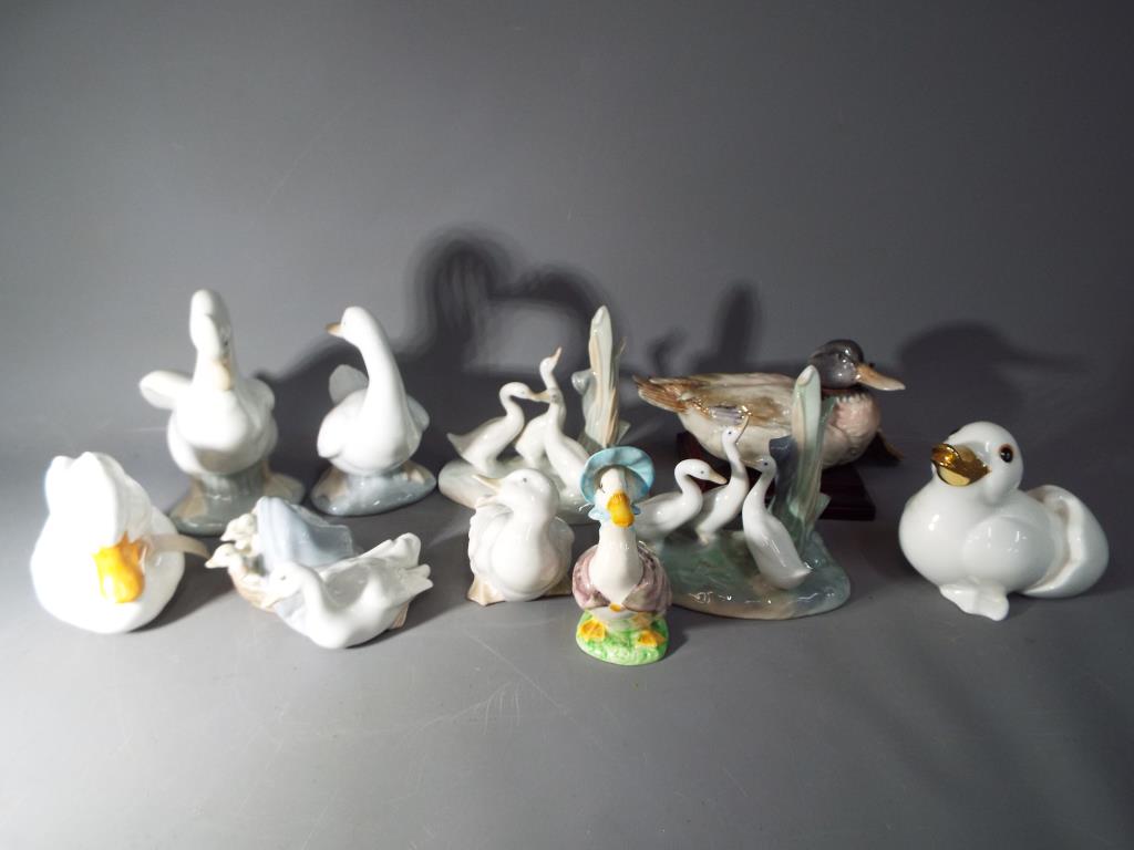 A quantity of ceramic figurines of ducks and geese to include Nao, Beswick,