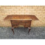 A small oak side unit with three one over two draws,