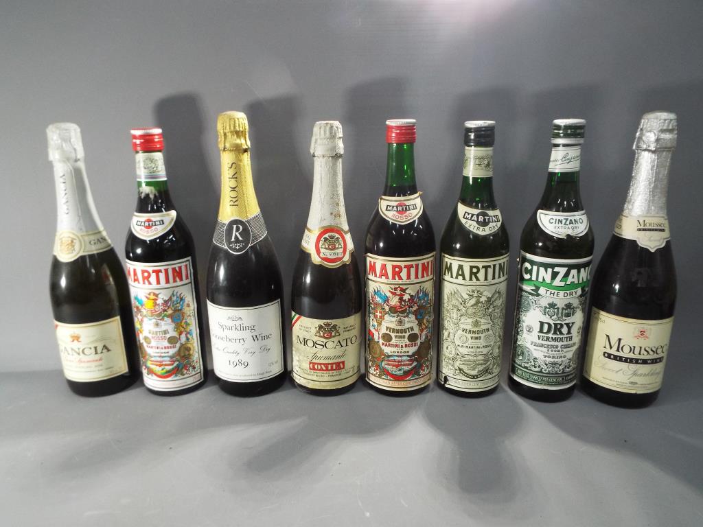 Eight bottles of drink to include Spumante, Martini, Cinzano and similar.