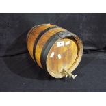 A wooden drinks barrel with attached tap, approximately 26 cm x 35 cm.