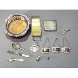 A good mixed lot of silver plate and metal ware to include spirit labels, cigarette case,