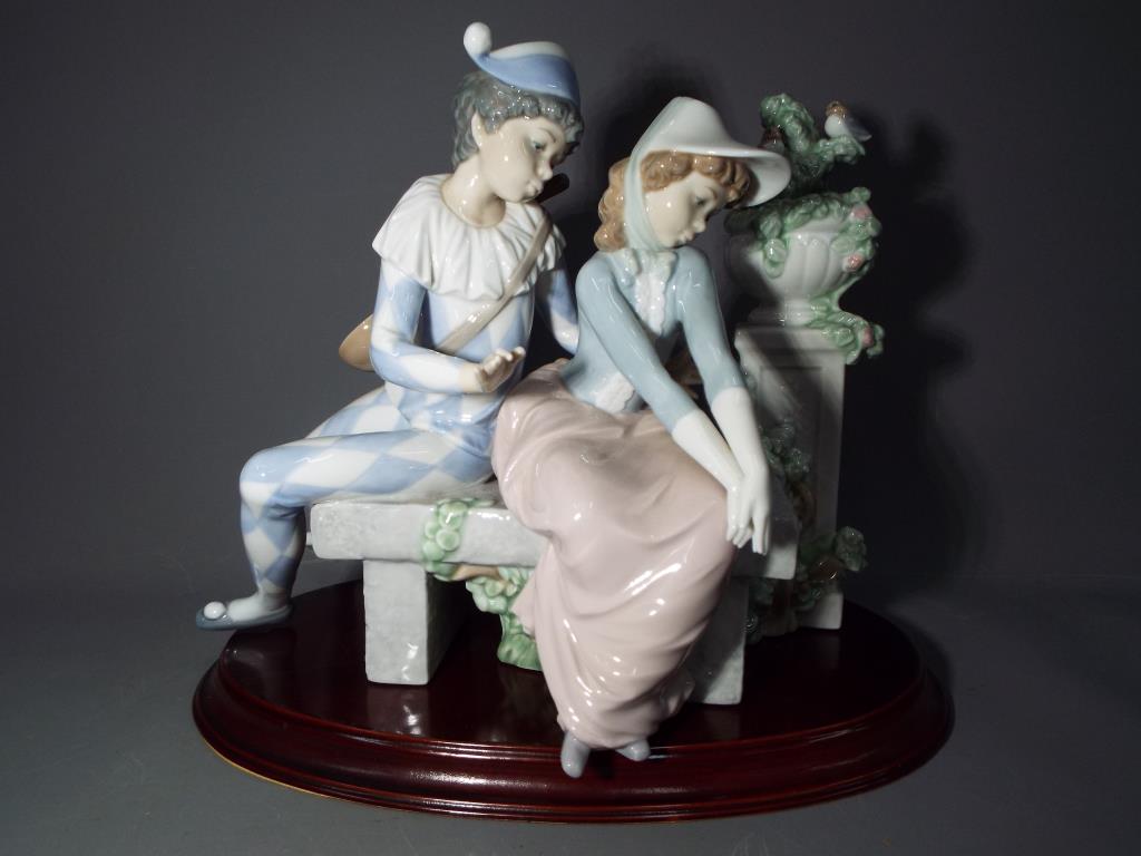 Nao - a Nao figural group depicting a Harlequin and a young girl,
