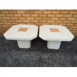 Two stone garden tables, measuring approximately 42 cm x 68 cm x 68 cm.