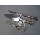 A small collection of silver hallmarked items to include silver handled cake knife and server,