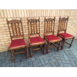 A set of four carved dining chairs with red upholstered drop-in seats,