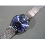 WWOOR - a modern stainless steel wristwatch with metallic blue dial and stainless hands by WWOOR,