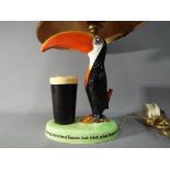 A Carlton Ware Guinness toucan lamp with shade, approximately 39 cm (h) including shade.