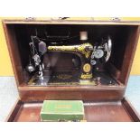 Singer Sewing Machine - a black and gold Singer sewing machine, reference number EA163452,