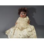 A German bisque headed Heubach Koppelsdorf doll marked to the back of the head '321 11/0',