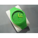 A modern green rubber wristwatch marked Ice with makers mark to the face and clasp,