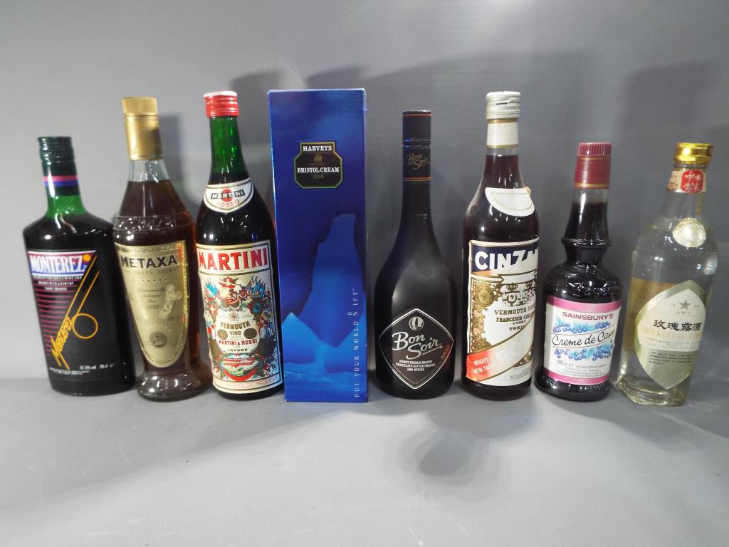 Eight bottles of drink to include Cinzano, Creme de Cassis, Metaxa,