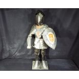 A metal model depicting a Knight in suit of armour, measuring approximately 77 cm [H].