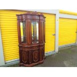 A bow fronted inlaid display unit with glass front,