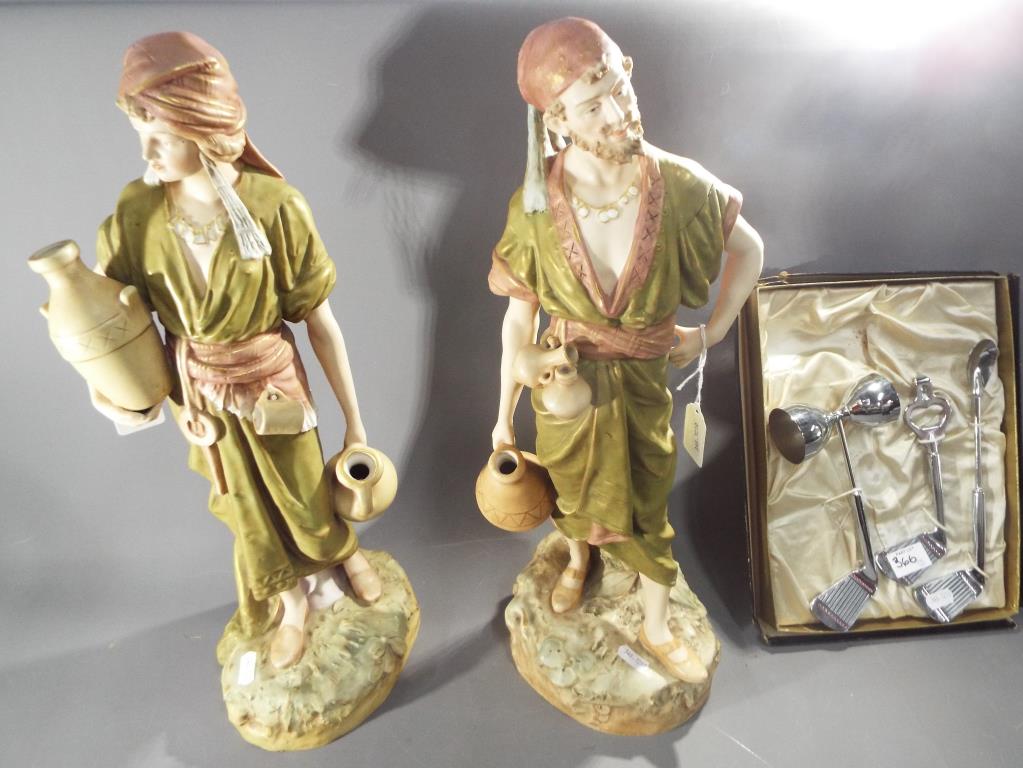 Royal Dux - a large pair of Royal Dux figures of water carriers, heightened in gilt,