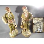Royal Dux - a large pair of Royal Dux figures of water carriers, heightened in gilt,