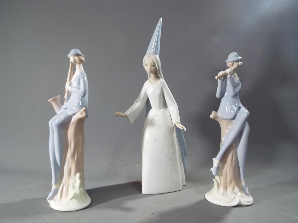 A Lladro figure depicting a young woman with tall conical hat,