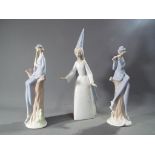 A Lladro figure depicting a young woman with tall conical hat,