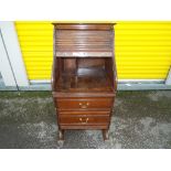 A two drawer roll front bureau,