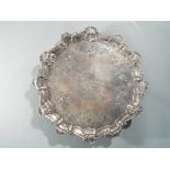 A George II silver salver with pie crust border and scallop shell detailing,