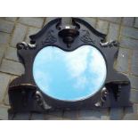 A highly carved bevelled edged mantle mirror, measuring approximately 37 cm x 94 cm.