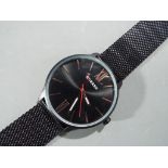 Curren - a gentleman's black metal modern wristwatch with rose plated hands, marked to face Curren,