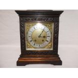 A carved oak mantel clock by Lenzkirch,