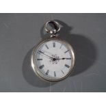 An ornate silver fob watch