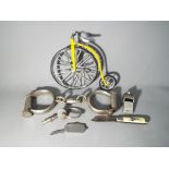 A small lot of mixed collectables to include as pair of Hiatt best handcuffs with key, Acme whistle,